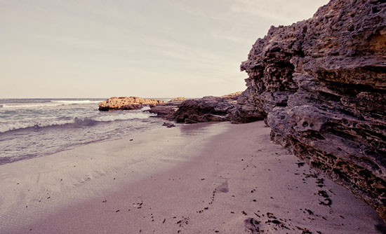 A secluded area of the beach in the late afternoon